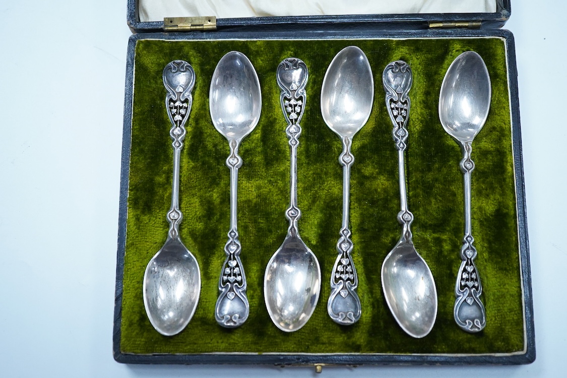 A cased set of six Edwardian Art Nouveau silver coffee spoons, Joseph Rodgers & Sons, Sheffield, 1908, 10.9cm, with pierced stylised terminals.